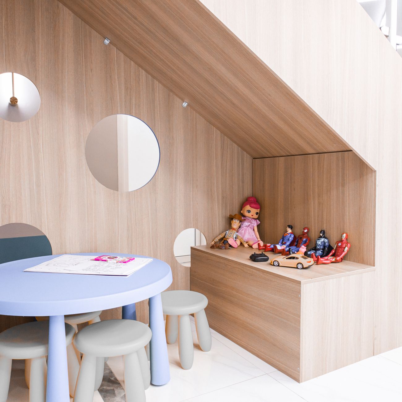 A playroom with a round table, stools and toys